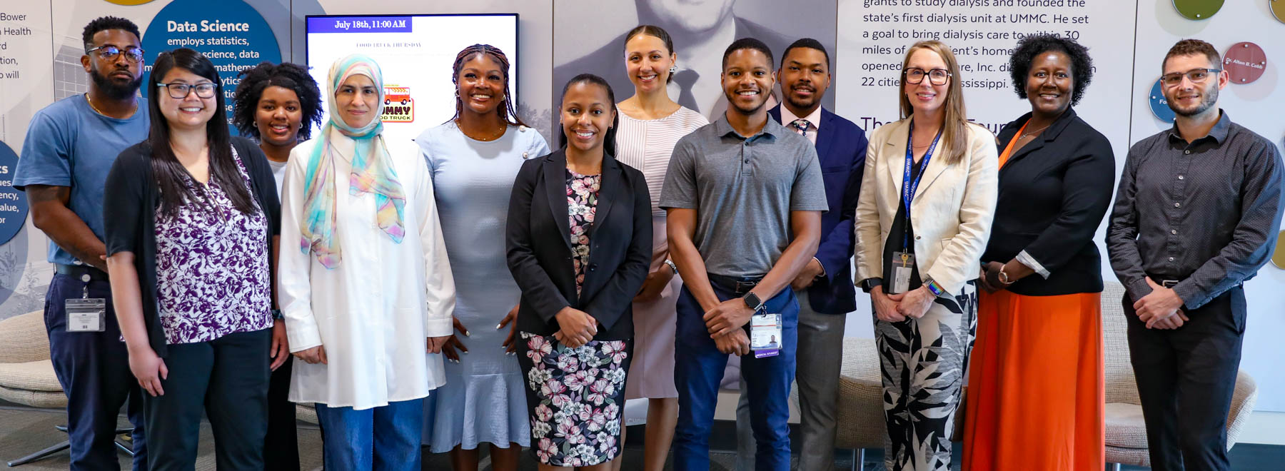 Students and faculty standing in the SOPH lobby